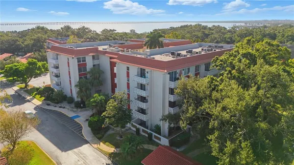 an aerial view of residential houses with outdoor space and trees