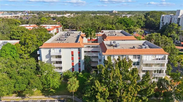an aerial view of multiple houses with a yard