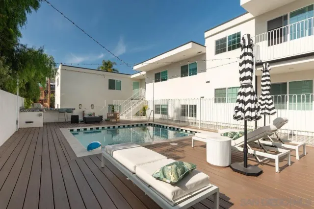 a view of a swimming pool with lounge chairs