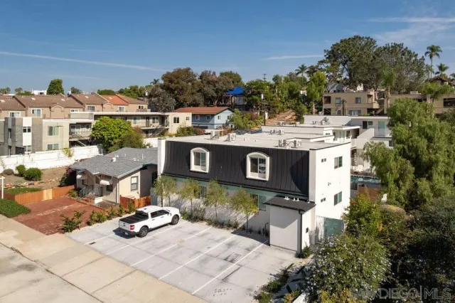 a view of a house with yard and sitting area