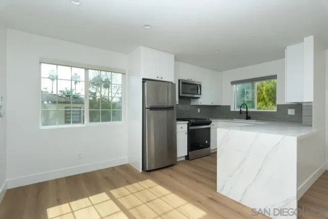a kitchen with a refrigerator stove and sink