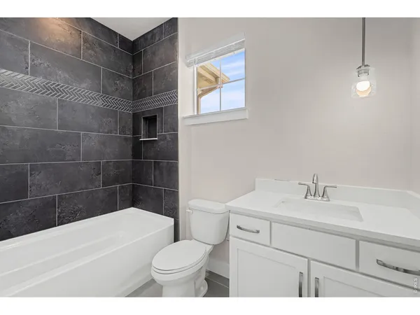 a bathroom with a sink a toilet and bathtub