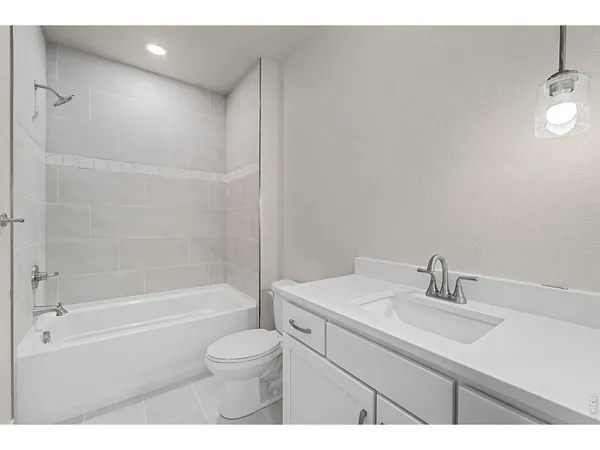 a bathroom with a sink toilet a vanity and bathtub