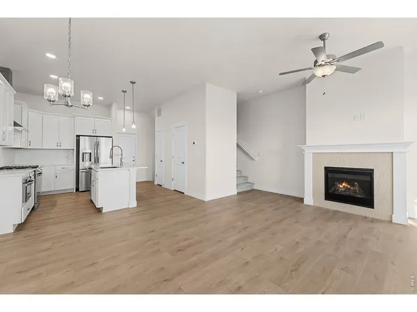 a view of kitchen and empty room with kitchen view