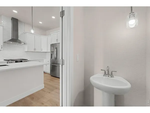 a kitchen with kitchen island a sink stainless steel appliances and cabinets
