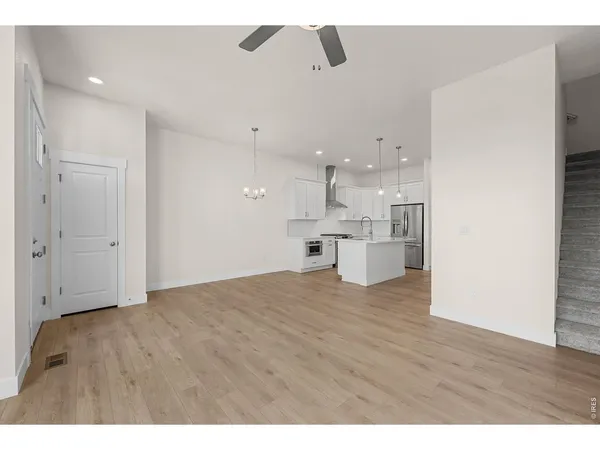 a view of a kitchen with a sink and wooden floor