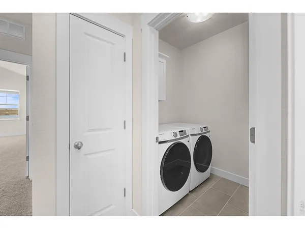 a view of a hallway with washer and dryer