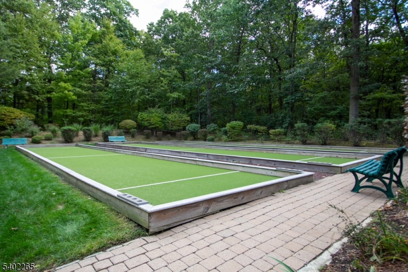 2201 Franklin Lane, Unit 2201 Rockaway, NJ 07866 - Photo 27 of 31 a view of a tennis court with a bench