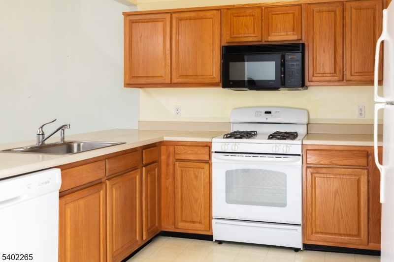 2201 Franklin Lane, Unit 2201 Rockaway, NJ 07866 - Photo 3 of 31 a kitchen with granite countertop cabinets stainless steel appliances and a sink