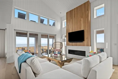 a living room with fireplace furniture and a flat screen tv