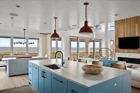 a kitchen with stainless steel appliances a sink a stove and a wooden floor