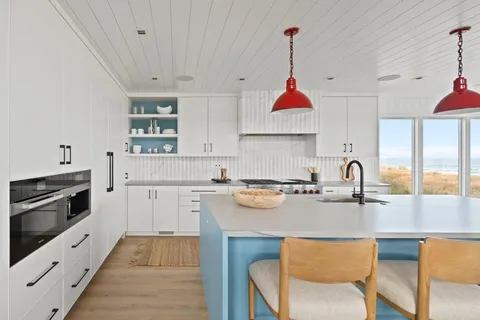 a kitchen with a stove a sink and a microwave