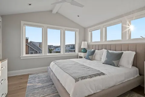 a bedroom with a large bed and a large window