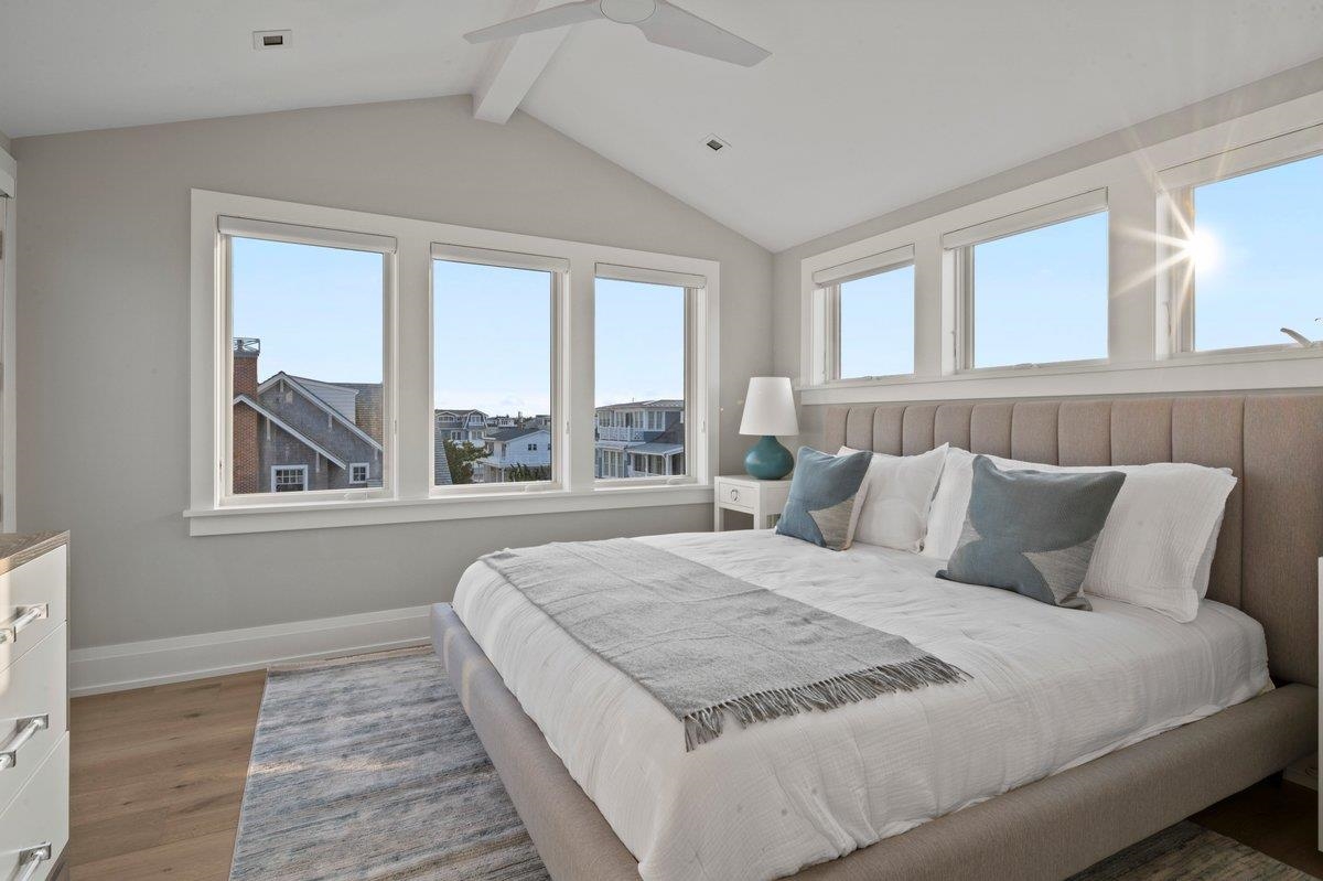 83 25th Street East Avalon, NJ 08202 - Photo 26 of 47 a bedroom with a large bed and a large window