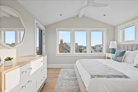 a spacious bedroom with a large bed and a chandelier