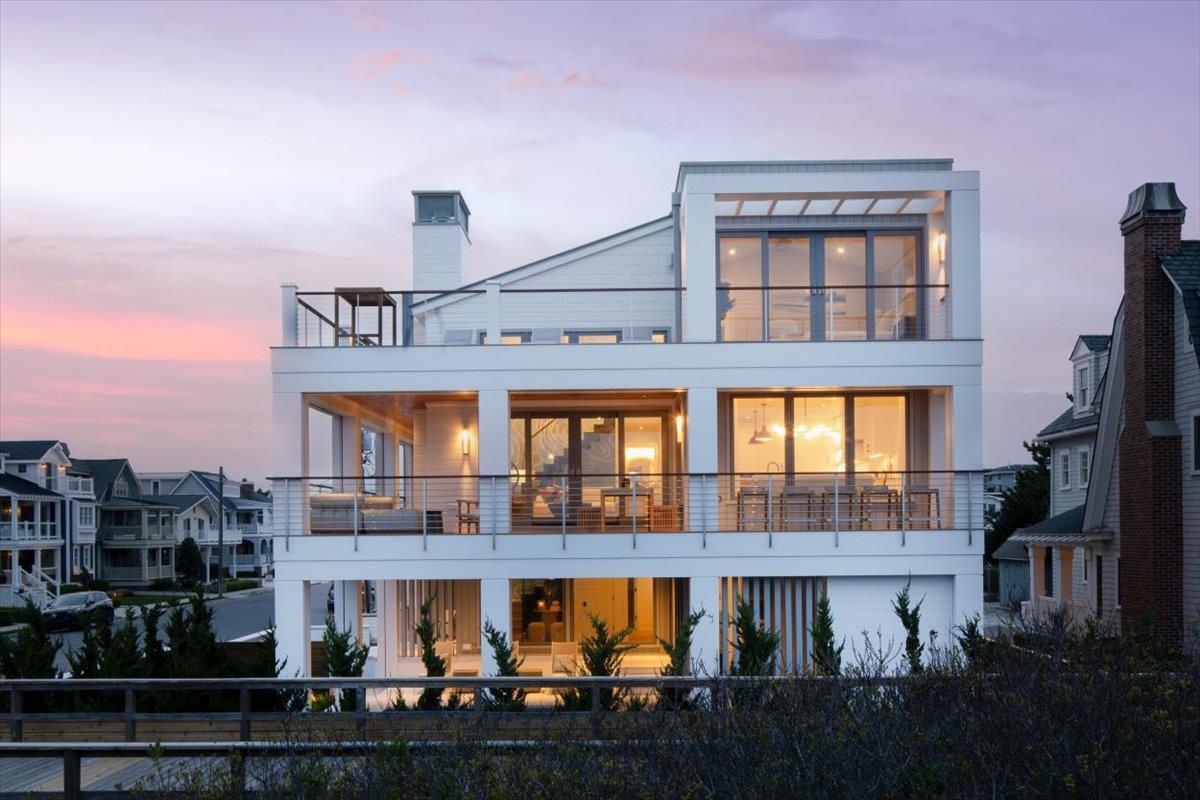 83 25th Street East Avalon, NJ 08202 - Photo 3 of 47 a front view of a building with glass windows and door