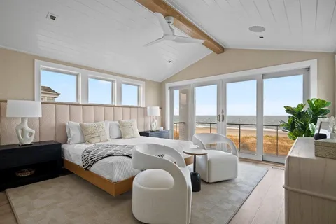 a bedroom with a bed and glass window