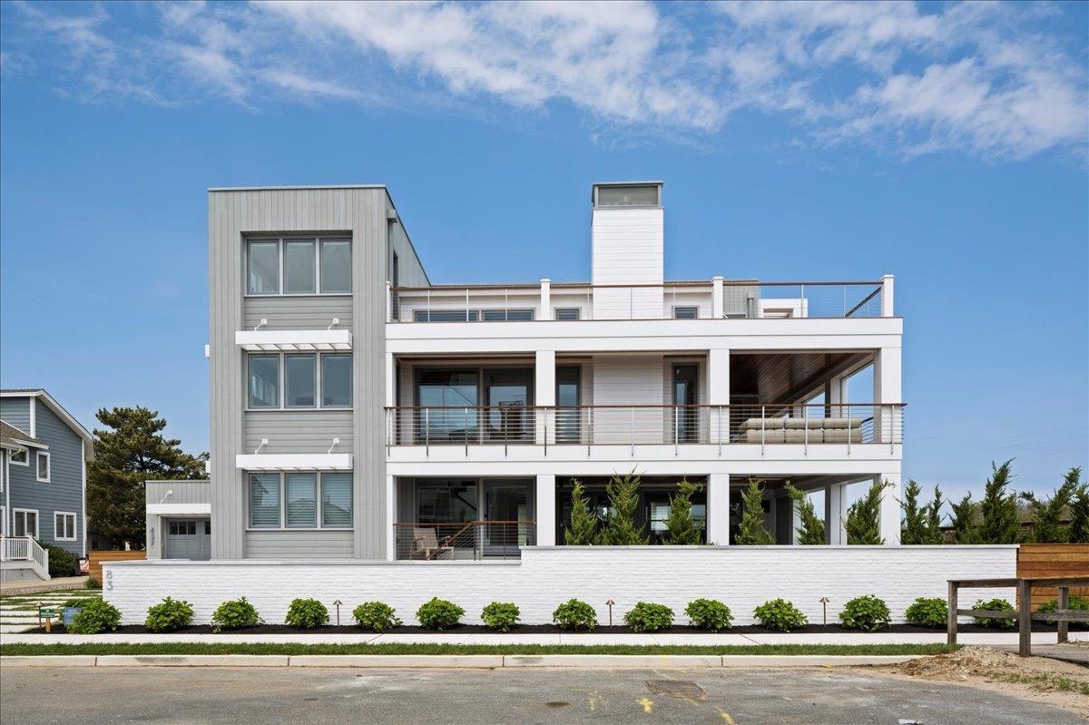 83 25th Street East Avalon, NJ 08202 - Photo 4 of 47 a front view of a building with street