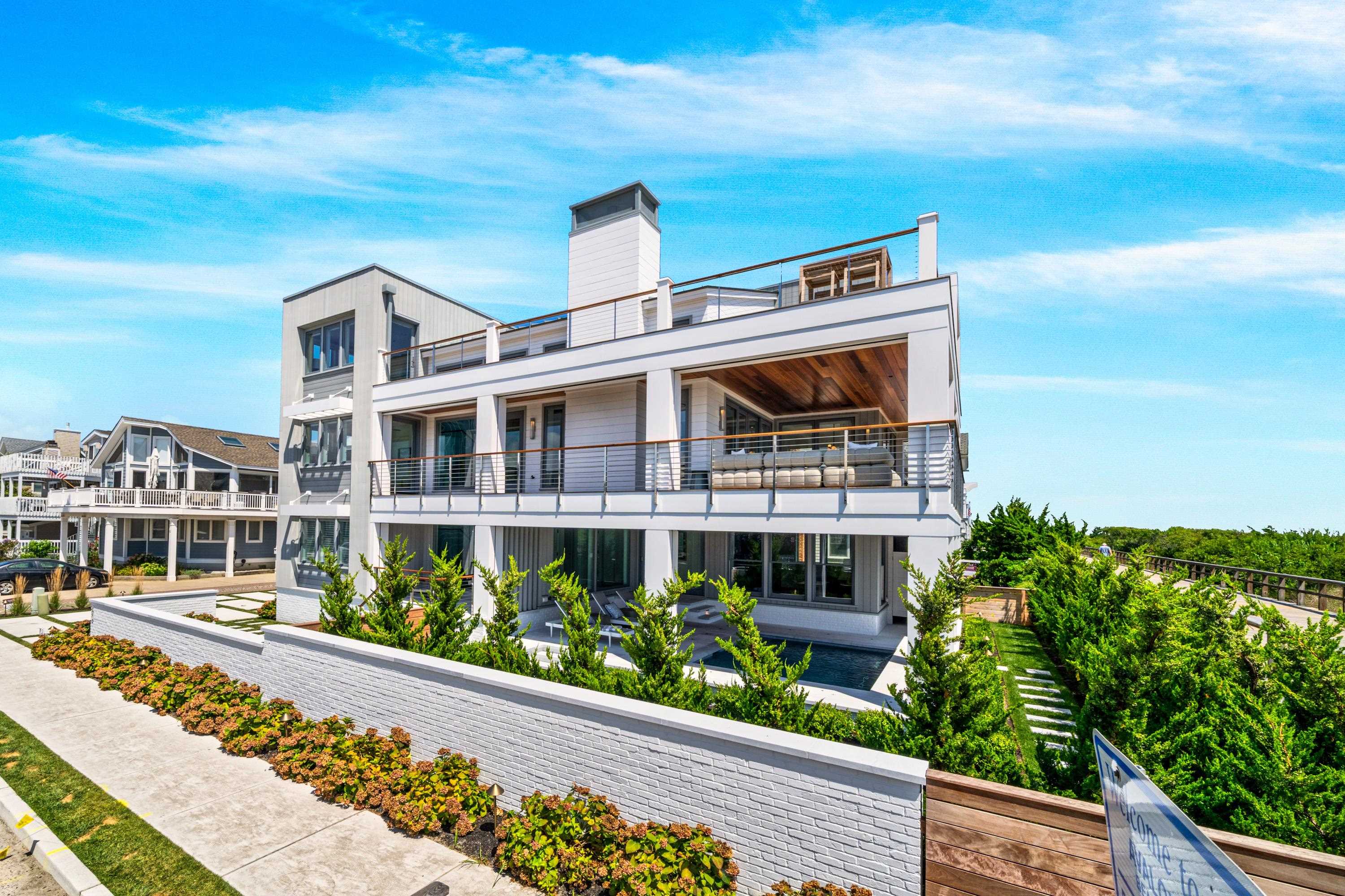 83 25th Street East Avalon, NJ 08202 - Photo 43 of 47 a front view of a house with a garden