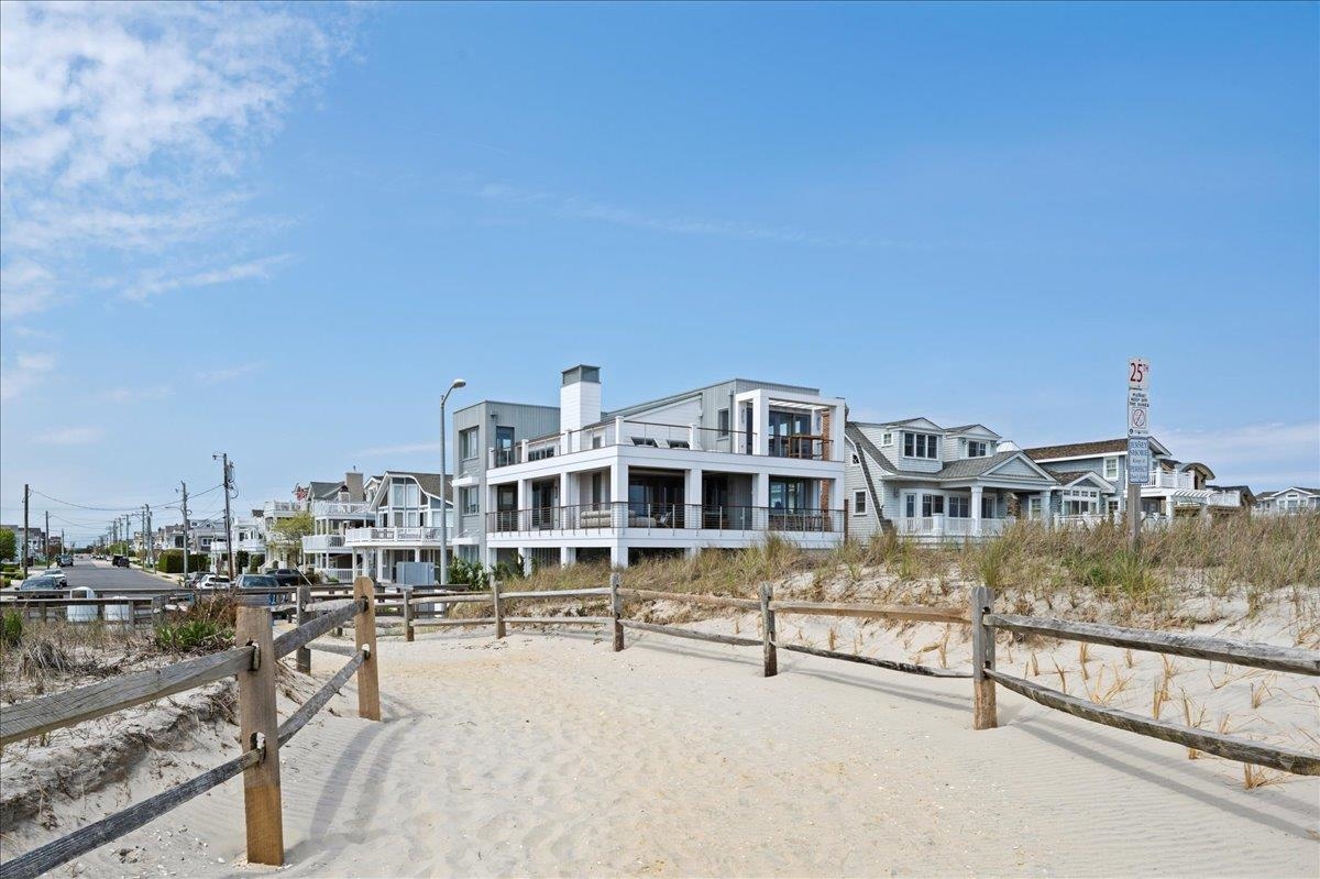 83 25th Street East Avalon, NJ 08202 - Photo 46 of 47 a front view of a building with glass top table and chairs