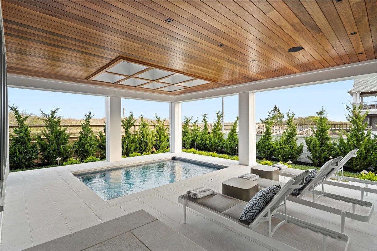 83 25th Street East Avalon, NJ 08202 - Photo 6 of 47 a view of a patio with a table and chairs