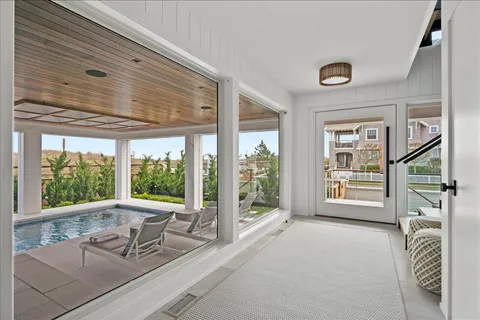 a view of a livingroom with furniture and floor to ceiling window