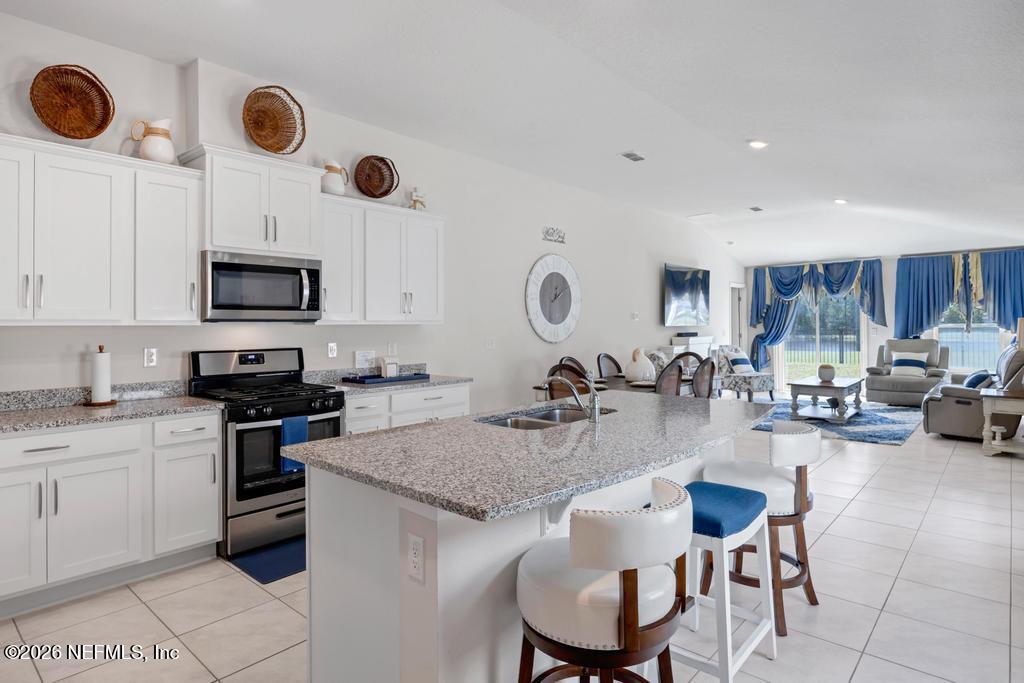 86178 Mainline Road Yulee, FL 32097 - Photo 12 of 61 a kitchen with sink stove and chairs