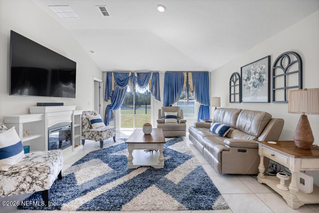 86178 Mainline Road Yulee, FL 32097 - Photo 15 of 61 a living room with furniture and a flat screen tv