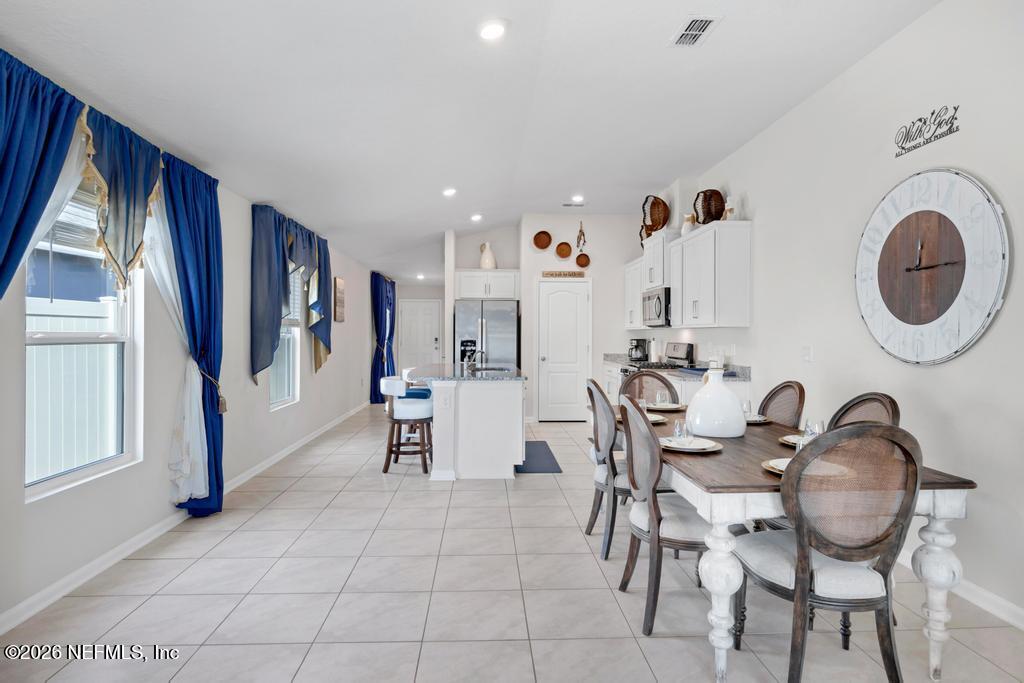 86178 Mainline Road Yulee, FL 32097 - Photo 19 of 61 a view of a dining room with furniture and chandelier