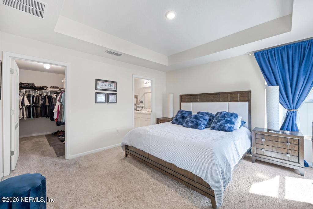 86178 Mainline Road Yulee, FL 32097 - Photo 25 of 61 a bedroom with a bed and a couch