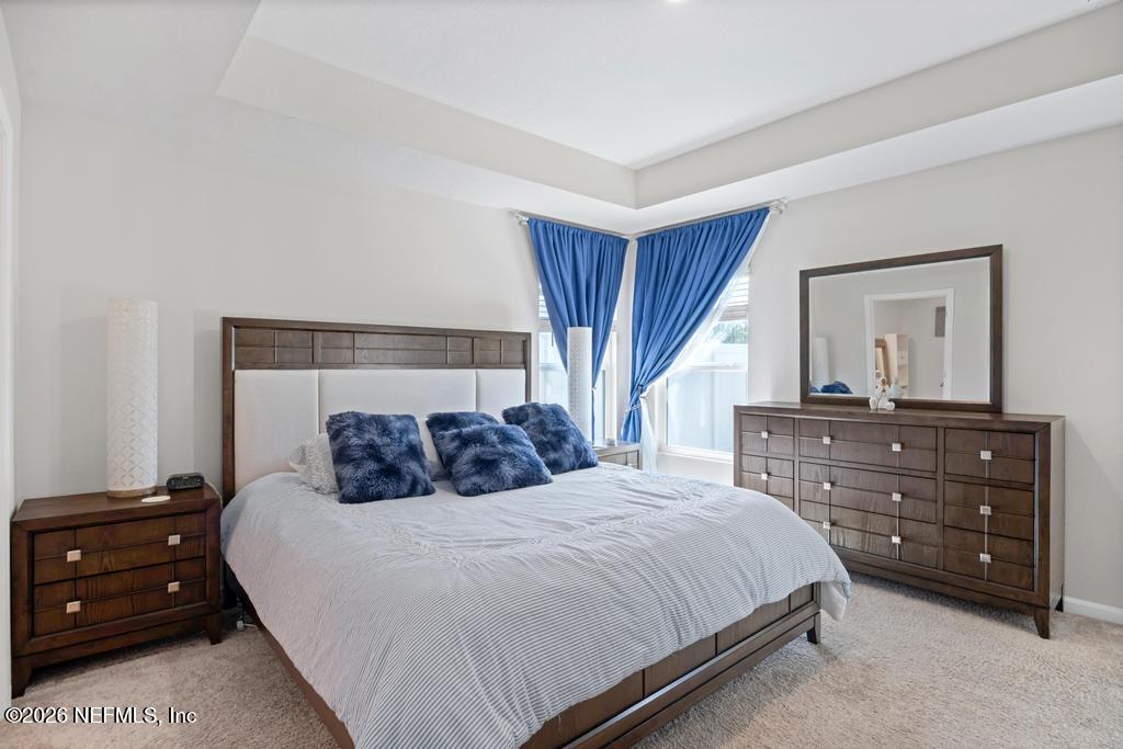 86178 Mainline Road Yulee, FL 32097 - Photo 26 of 61 a bedroom with a bed and a dresser