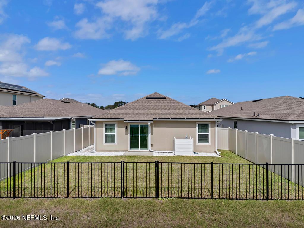 86178 Mainline Road Yulee, FL 32097 - Photo 51 of 61 a front view of a house with a garden