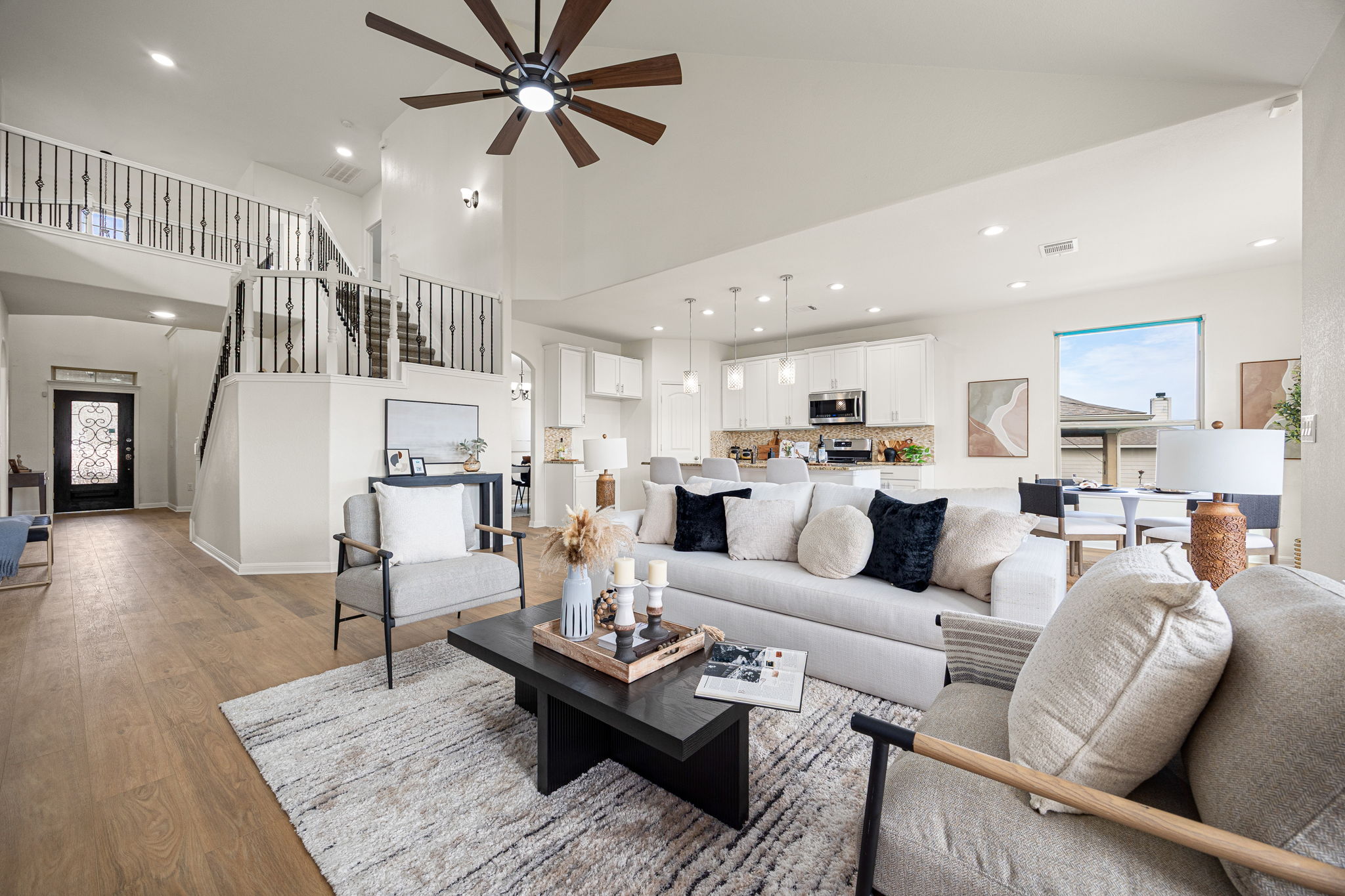 a living room with furniture kitchen view and a table