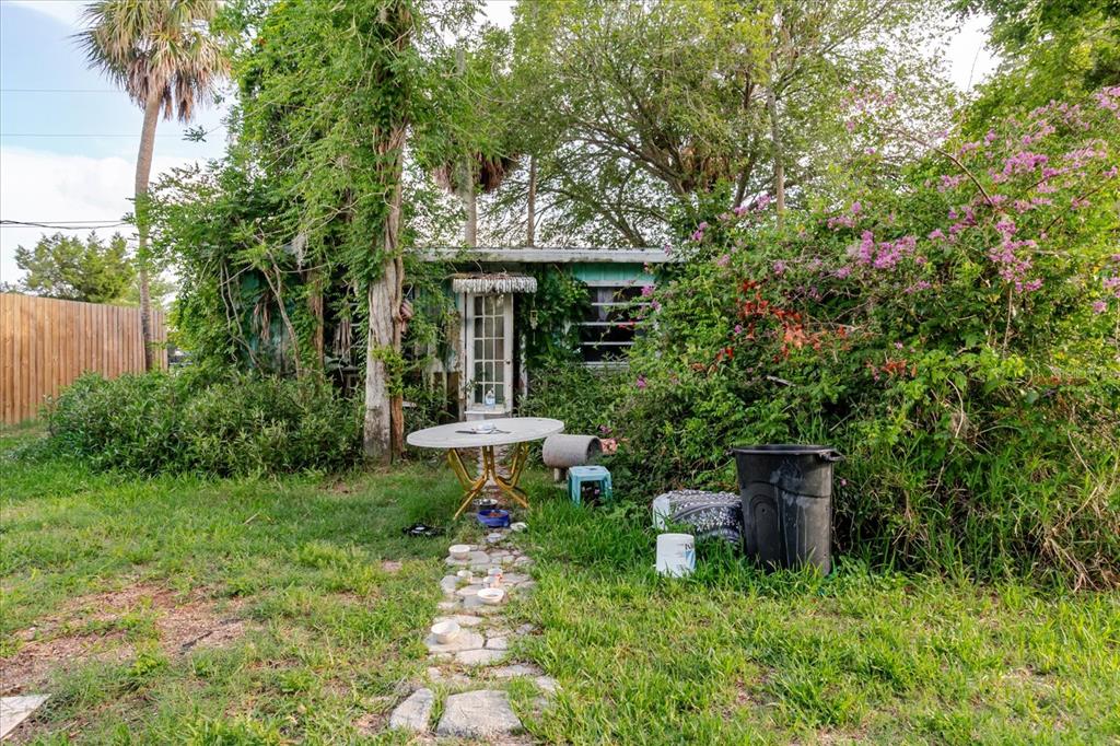5323 Circle Drive Weeki Wachee, FL 34607 - Photo 55 of 77 a view of backyard with a table and chairs and a large tree
