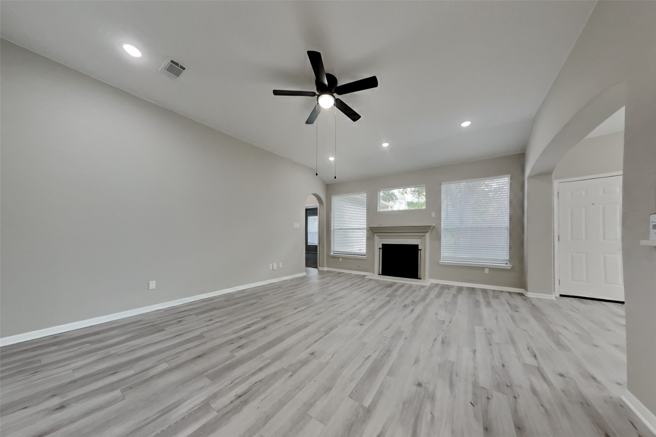 2014 Ridgeway Park Drive Houston, TX 77339 - Photo 3 of 19 an empty room with wooden floor ceiling fan and windows