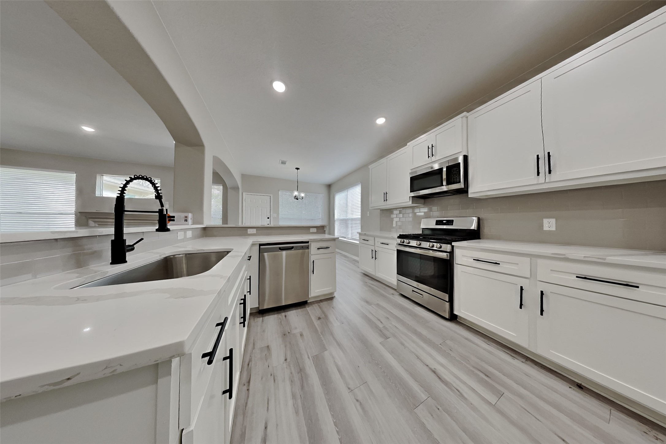 2014 Ridgeway Park Drive Houston, TX 77339 - Photo 5 of 19 a kitchen with stainless steel appliances a sink dishwasher a stove top oven a refrigerator with island and cabinets with wooden floor