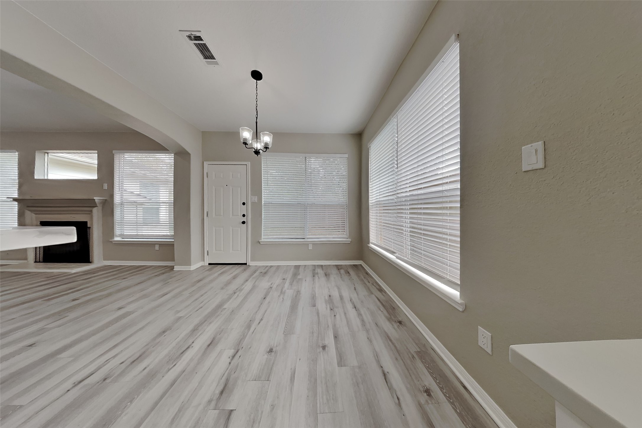 2014 Ridgeway Park Drive Houston, TX 77339 - Photo 7 of 19 a view of an empty room with wooden floor fireplace and a window