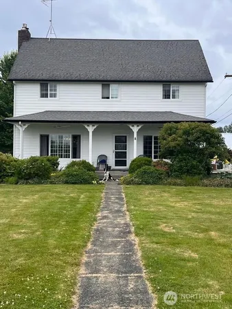 a front view of a house with a garden