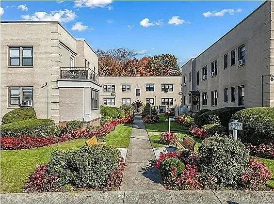 a front view of a house with a yard and outdoor seating