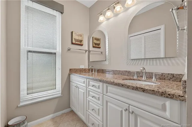 a bathroom with a granite countertop sink a mirror and a