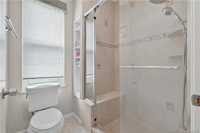 a white toilet sitting next to a bathroom sink