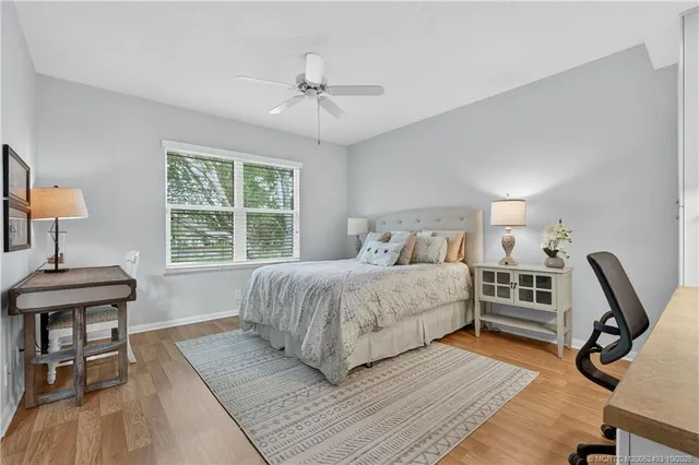 a bedroom with a bed a table and chair