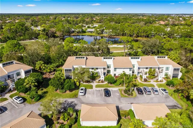 an aerial view of residential houses with outdoor space and swimming pool