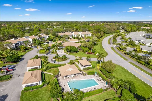 an aerial view of residential houses with outdoor space and swimming pool