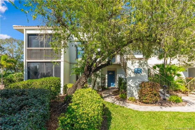 a view of a house with a tree in a yard