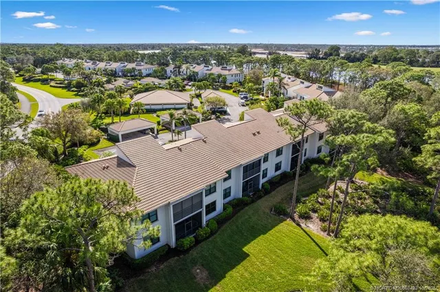 an aerial view of a house with a yard basket ball court and outdoor seating