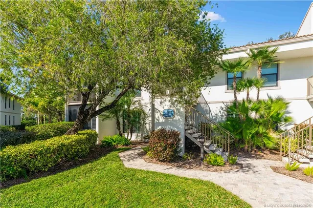 a view of a backyard with plants and patio