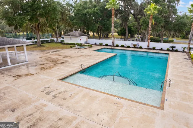 a view of a swimming pool with chairs and tables