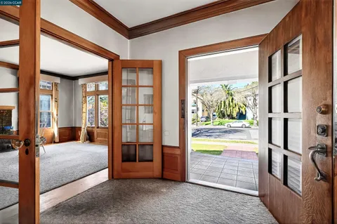 a bedroom with furniture and large windows