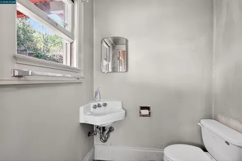 a bathroom with a sink toilet and mirror